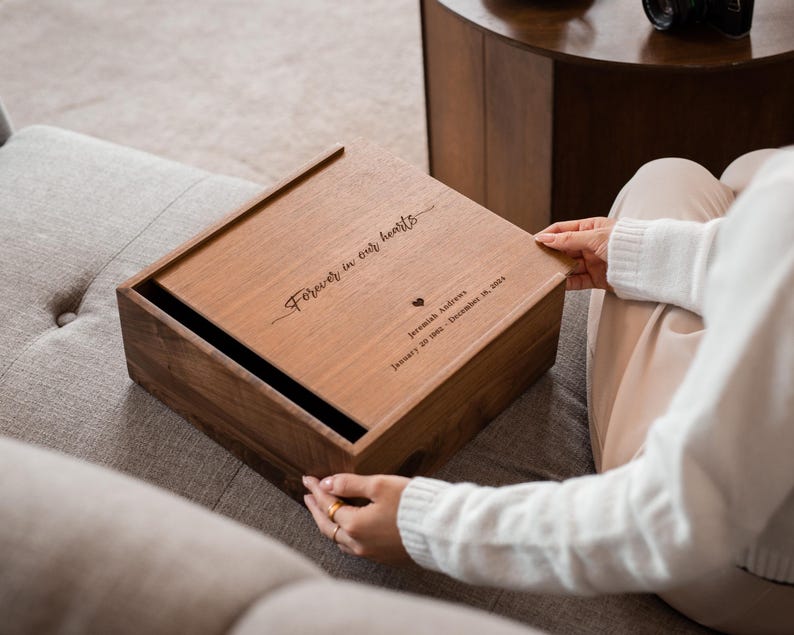 Real Etsy listing photograph of an engraved walnut memorial box with a sliding lid